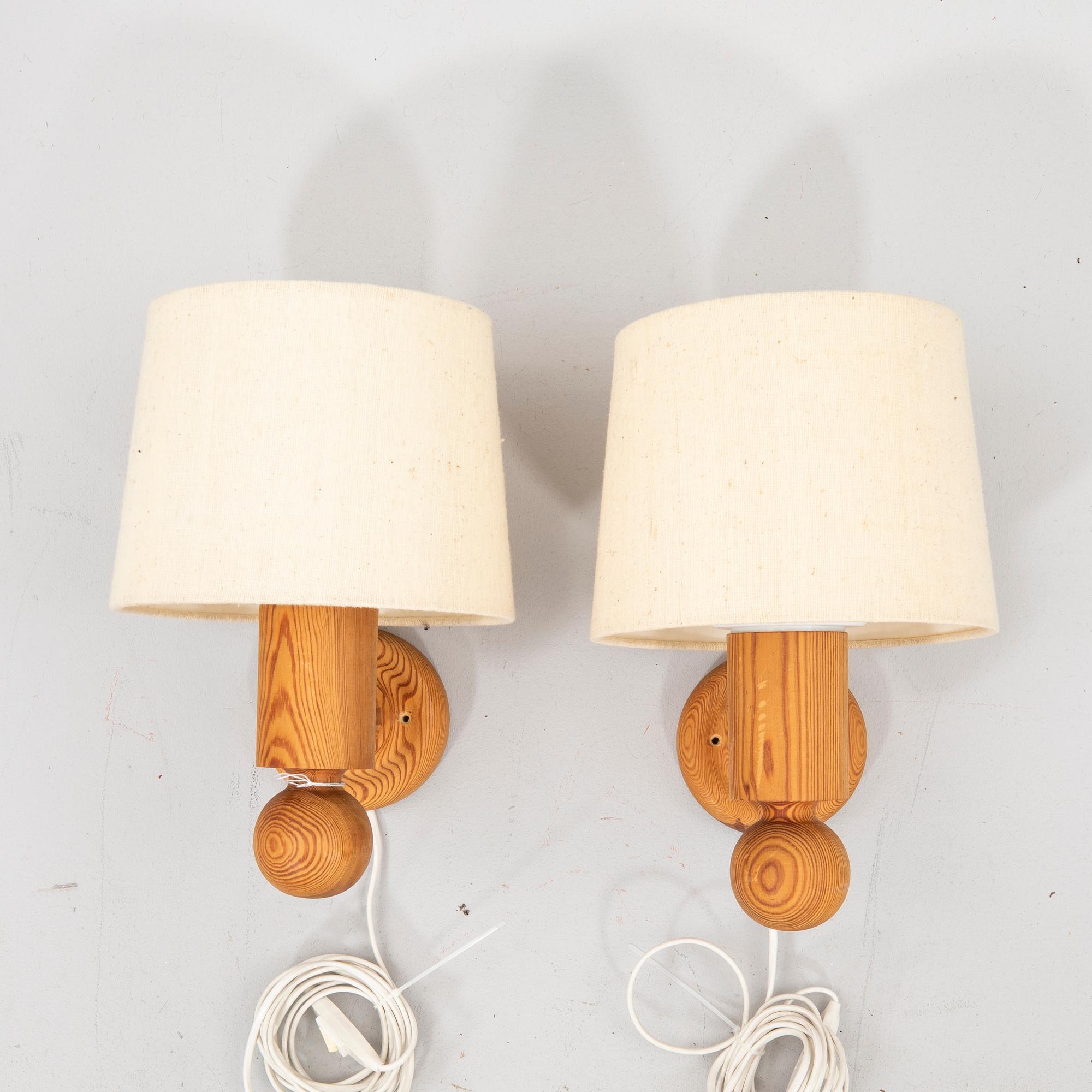 Uno & Östen Kristansson, a pair of pine wall lamps  from Luxus 1970s.