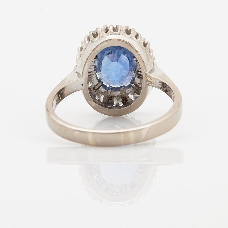 An 18K whithe gold ring set with a faceted sapphire weight 3.93 cts according to engraving.