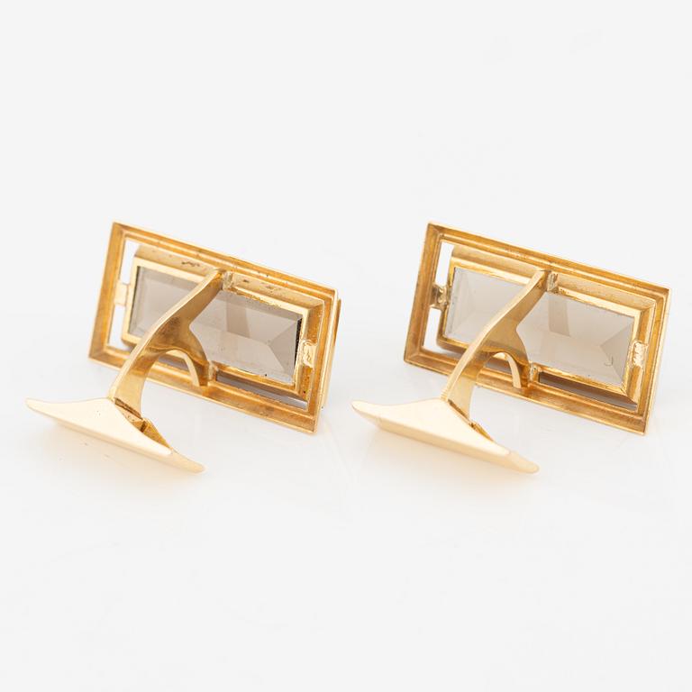 A pair of cufflinks in 18K gold with smoky quartz.