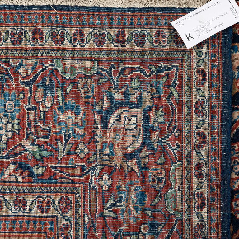 A CARPET. A semi-antique Kashan part silk. 248,5 x 136 cm.