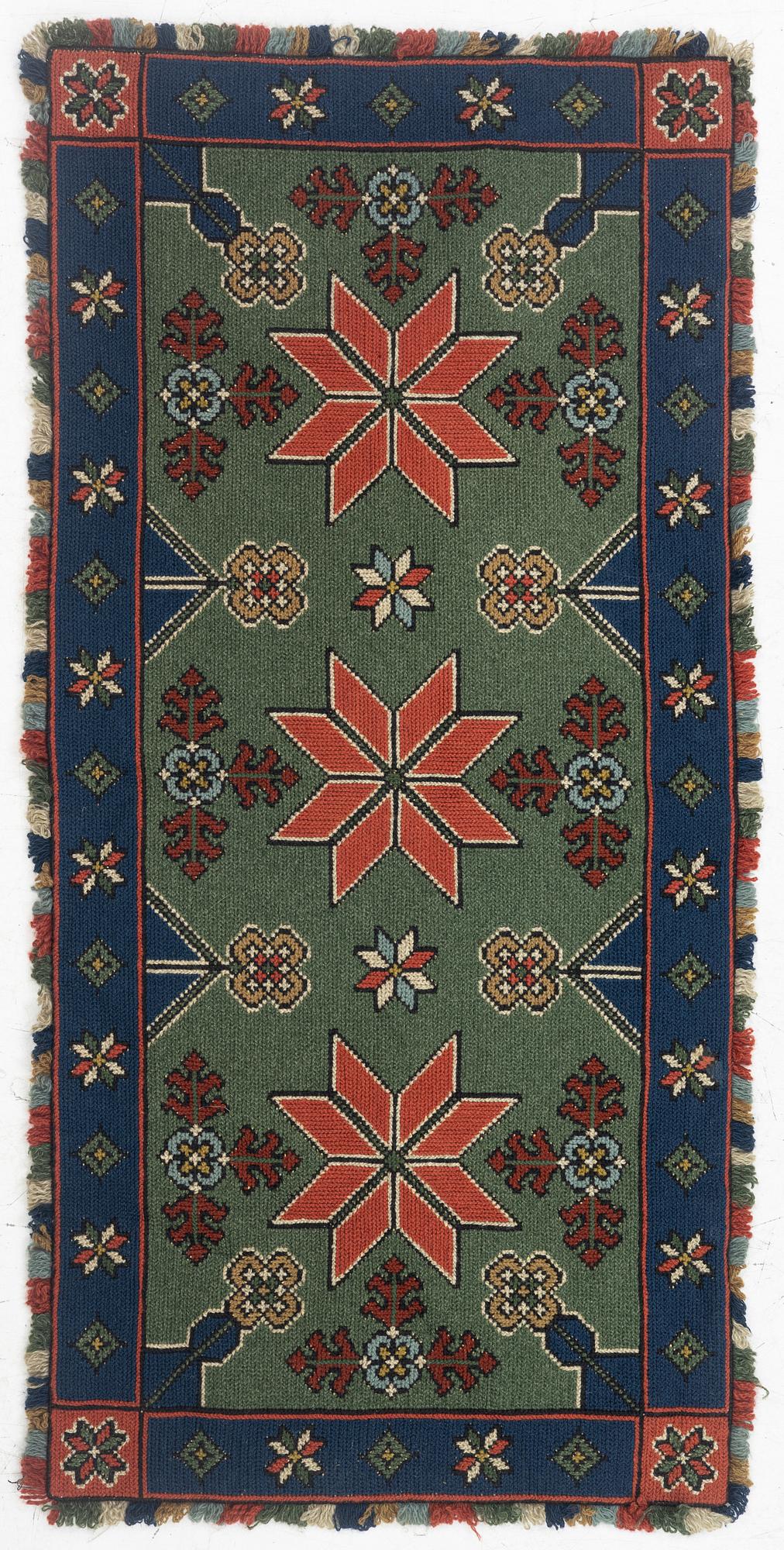A Scania cross-stitch embroidered cushion, Sweden, around 1900, c. 99 x 47 cm.