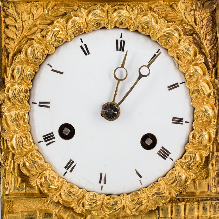 A French Empire early 19th century gilt bronze mantel clock.