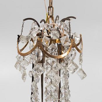 A Louis XVI gilt-brass and cut glass nine-light chandelier, circa 1800.