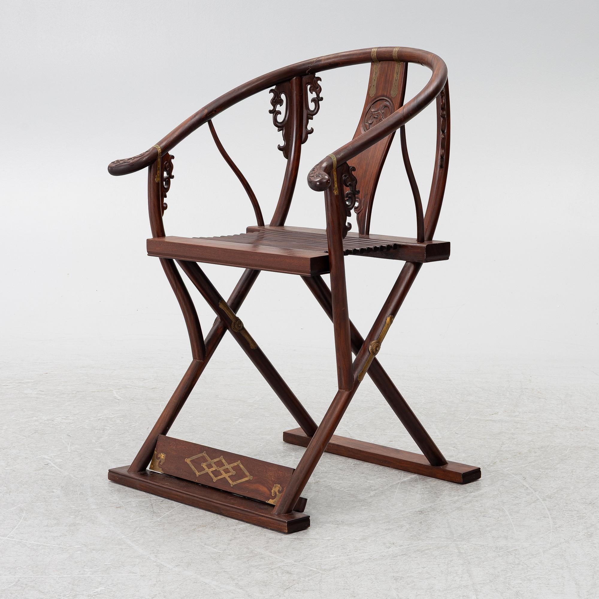 A Chinese hardwood folding chair, 20th century.