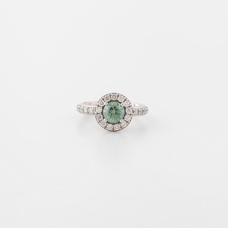 A treated green diamond and briliant cut diamonds.