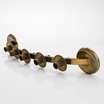 A mid-20th century brass candle holder, Idman.