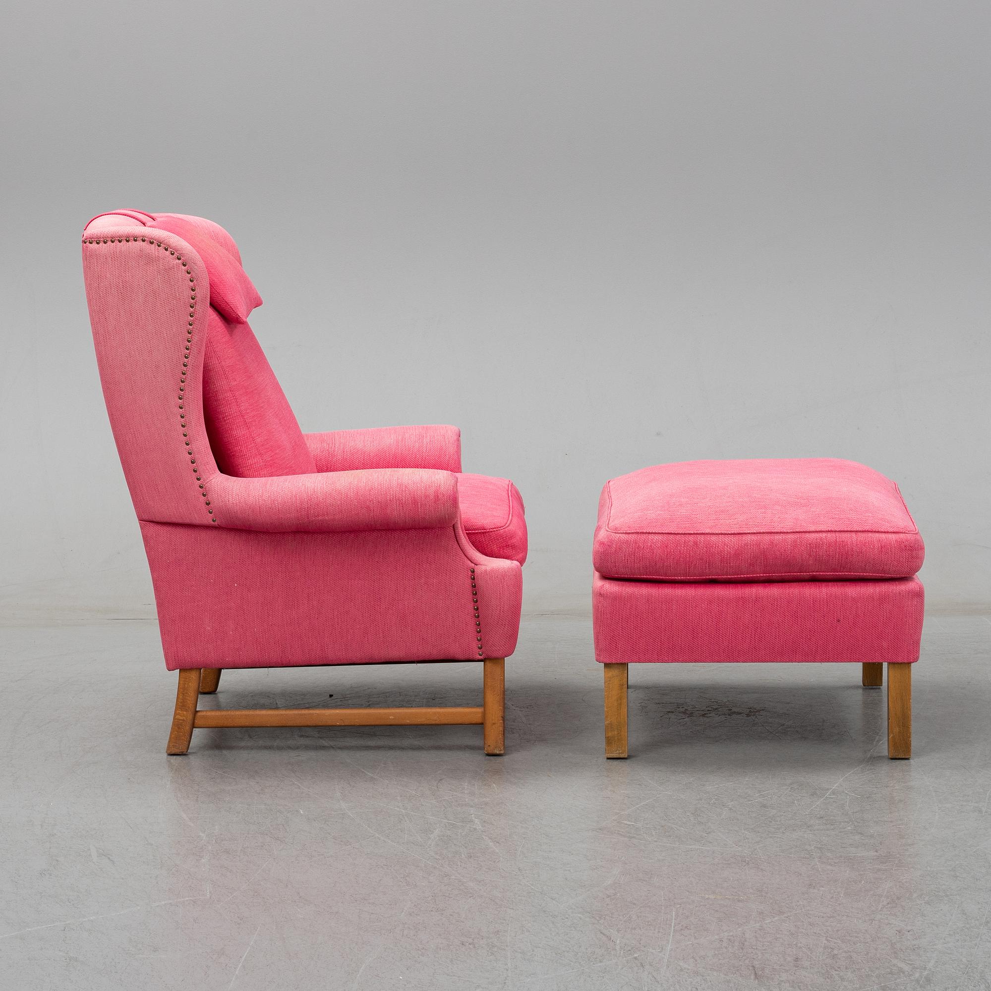 An 'Oxford' model no 3543 easy chair with stool by Ragnar Helsén for Firma Svenskt Tenn.