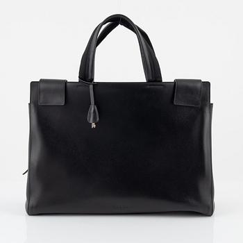 Prada, a black leather bag.