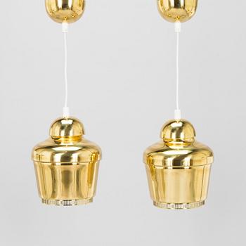 Alvar Aalto, A pair of  A 330, 'Golden Bell' pendant lights A330 for Artek, 2000s.