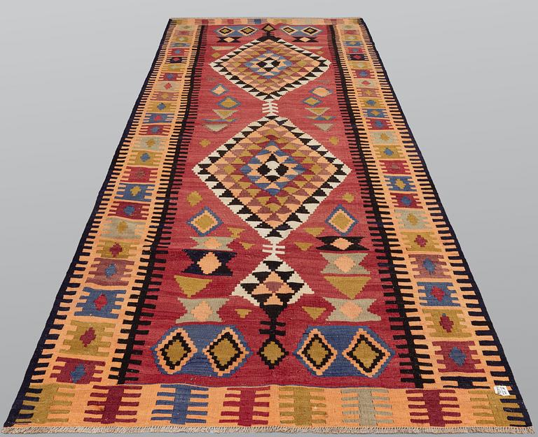 A Persian Nomad Kilim carpet, c 383 x 160 cm.