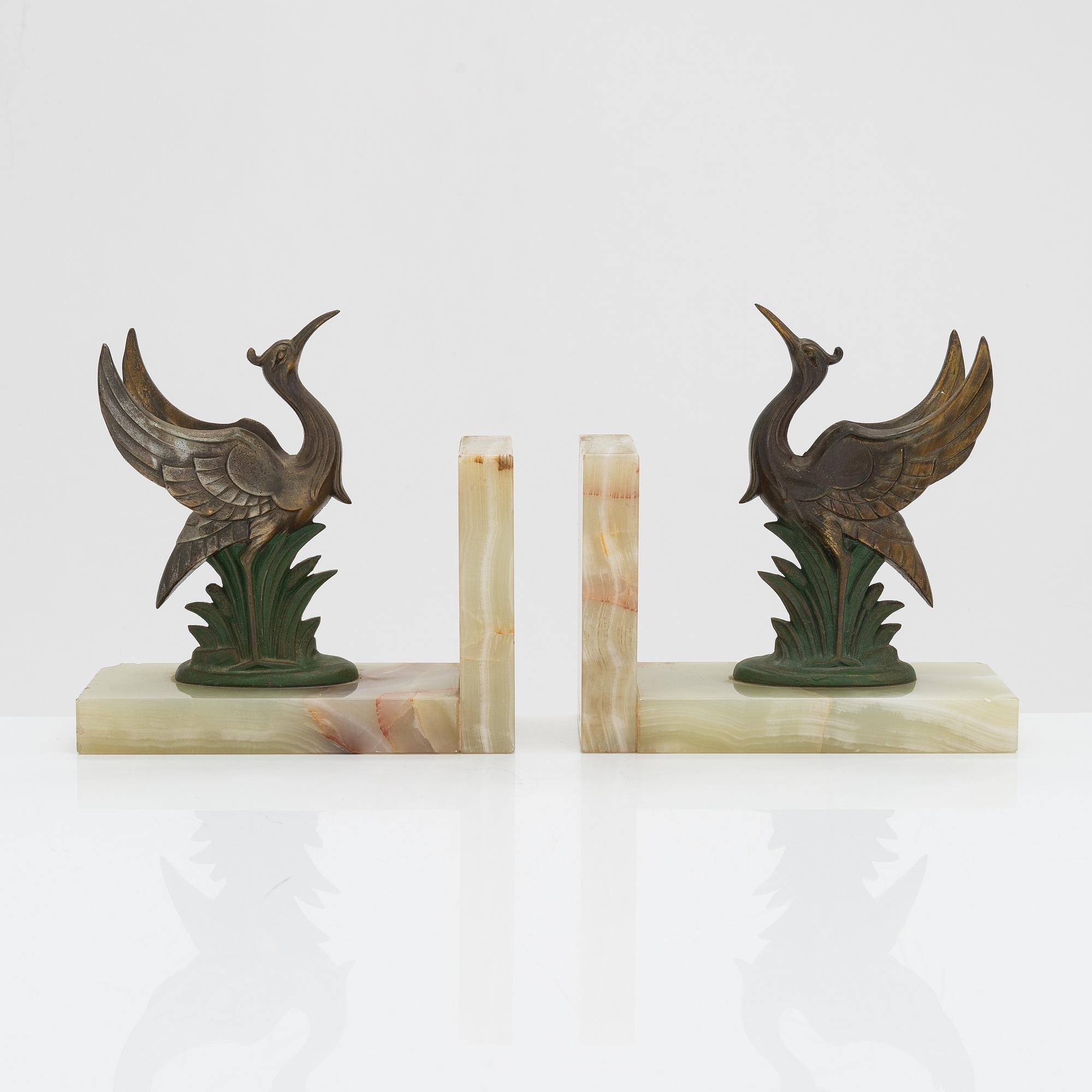 A pair of alabaster and  patinated metal Art Deco bookends from the first half of the 20th Century.