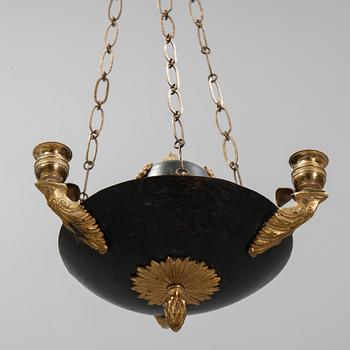 A Swedish Empire style 20th century three-light patinated brass hanging-lamp.