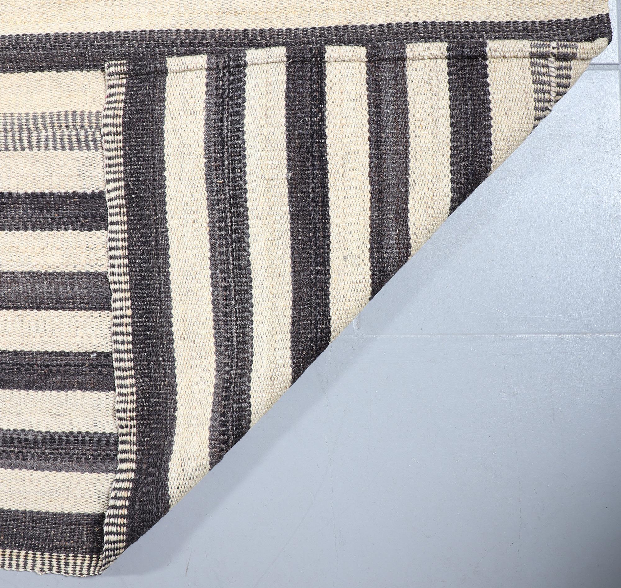 A FLATWEAVE RUG, 292 x 246 cm.