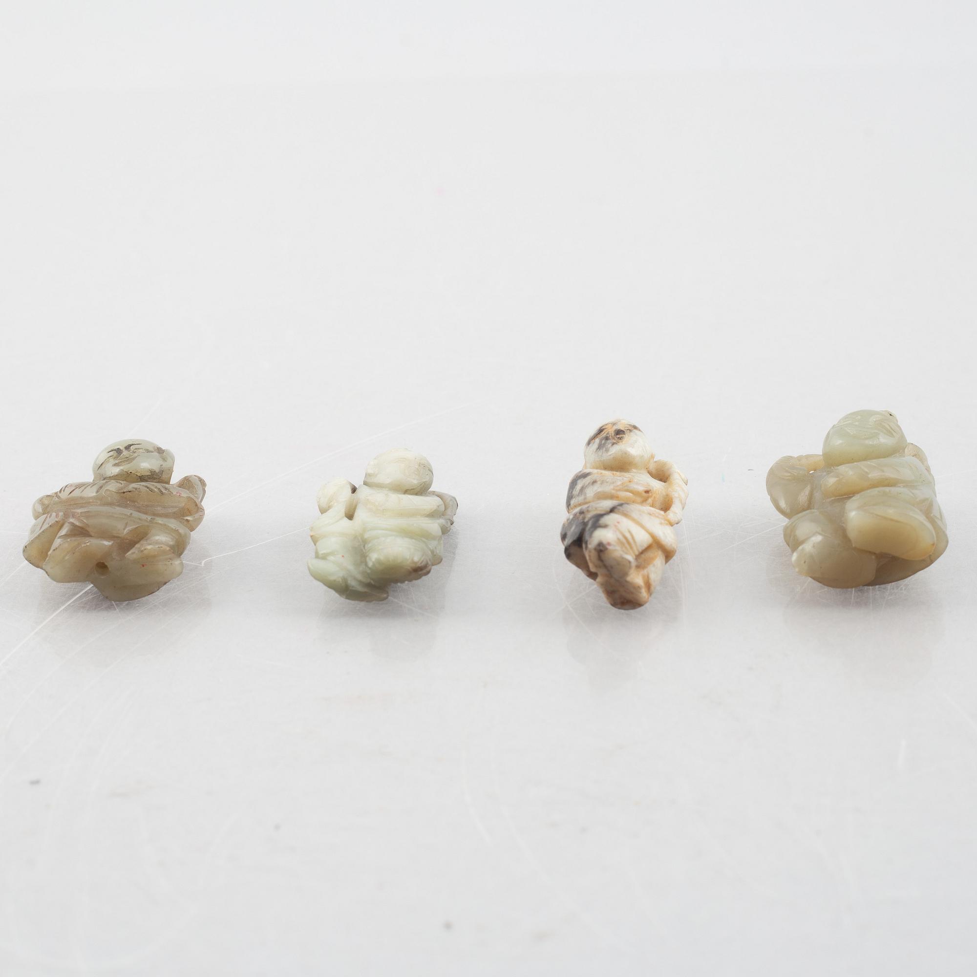 A group of four Chinese stone charms, 20th century.