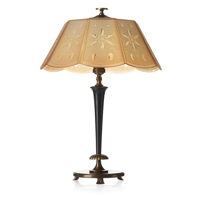 A 1920's patinated metal, lacquered wood, etched och cut glass table lamp, unknown designer, 1920's.