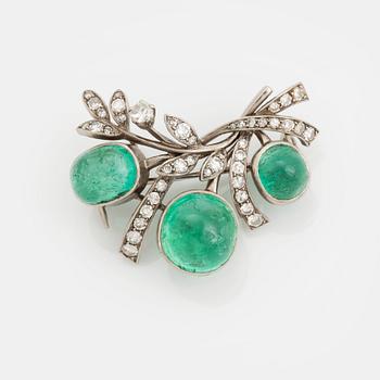 375. A WA Bolin brooch in 18K white gold set with a cabochon-cut emerald and eight-cut diamonds.