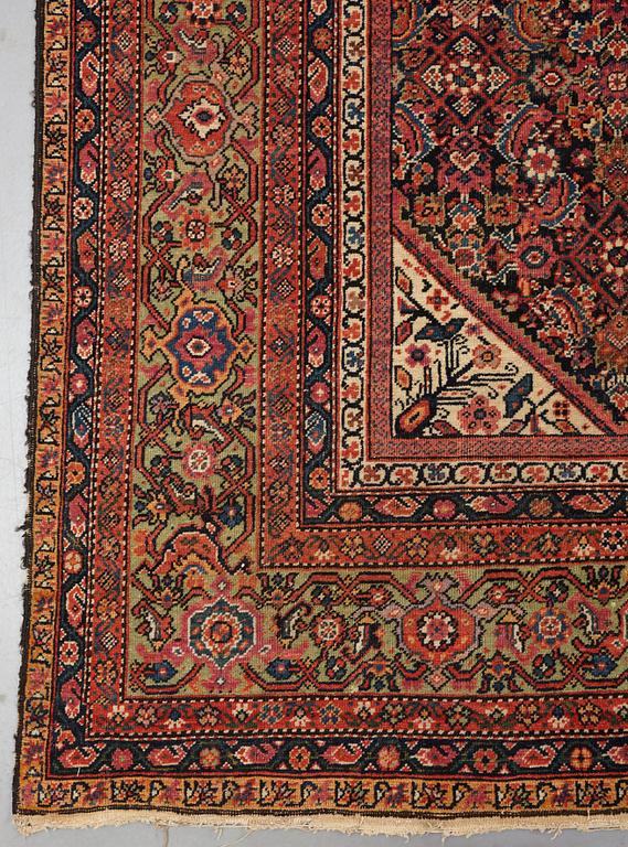 A carpet, an antique Feraghan, ca 579,5 x 234,5 cm.