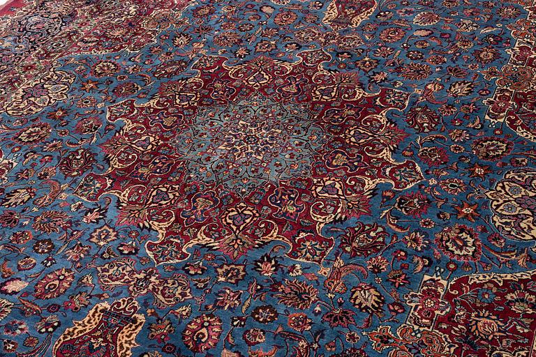 A Mashad carpet, signed Saber, c. 468 x 248 cm.