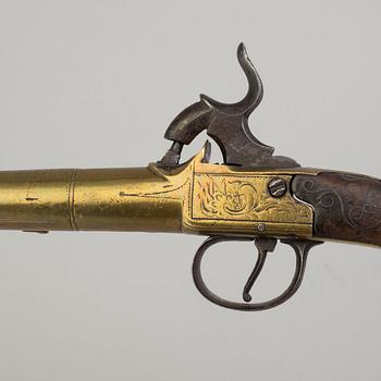 A secon half of the 19th century pair of Queen Anne brass percussion pistols converted from flintlock by Brueton, London.