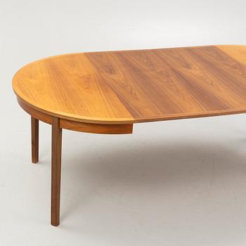 A walnut-veneered dining table, 1960's/70's.