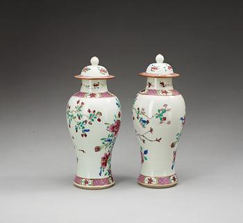 A pair of famille rose vases with covers, Qing dynasty (1736-95).