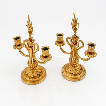 A pair of Louis XV-style bronze candelabras.