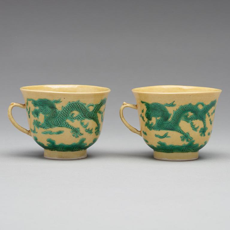 A pair of yellow glazed tea cups with stands, Qing dynasty with Guangxus six character mark (1875-1908).