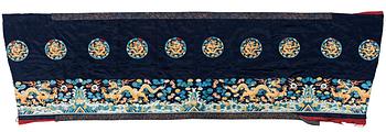 106. AN ALTAR DRAPE, embroidered silk. A fragment. China late Qing dynasty. 66,5 x 213-231,5 cm.