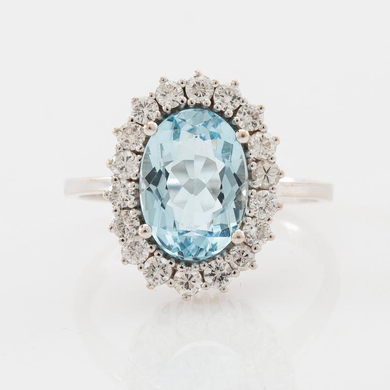 Ring 18K white gold set with an oval faceted aquamarine and round brilliant-cut diamonds.