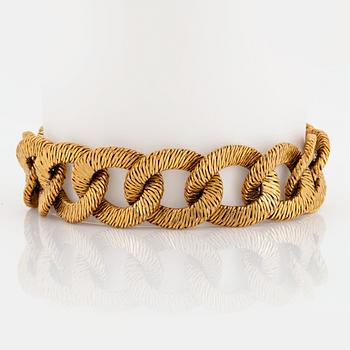 An 18K gold bracelet.