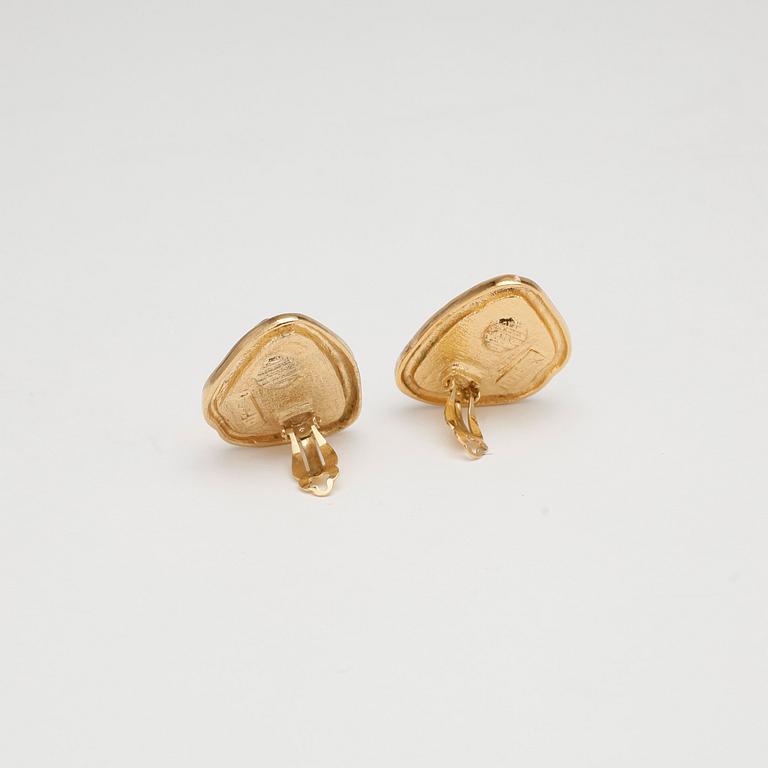 YVES SAINT LAURENT, a pair of yellow glass earclips set in gold colored metal.
