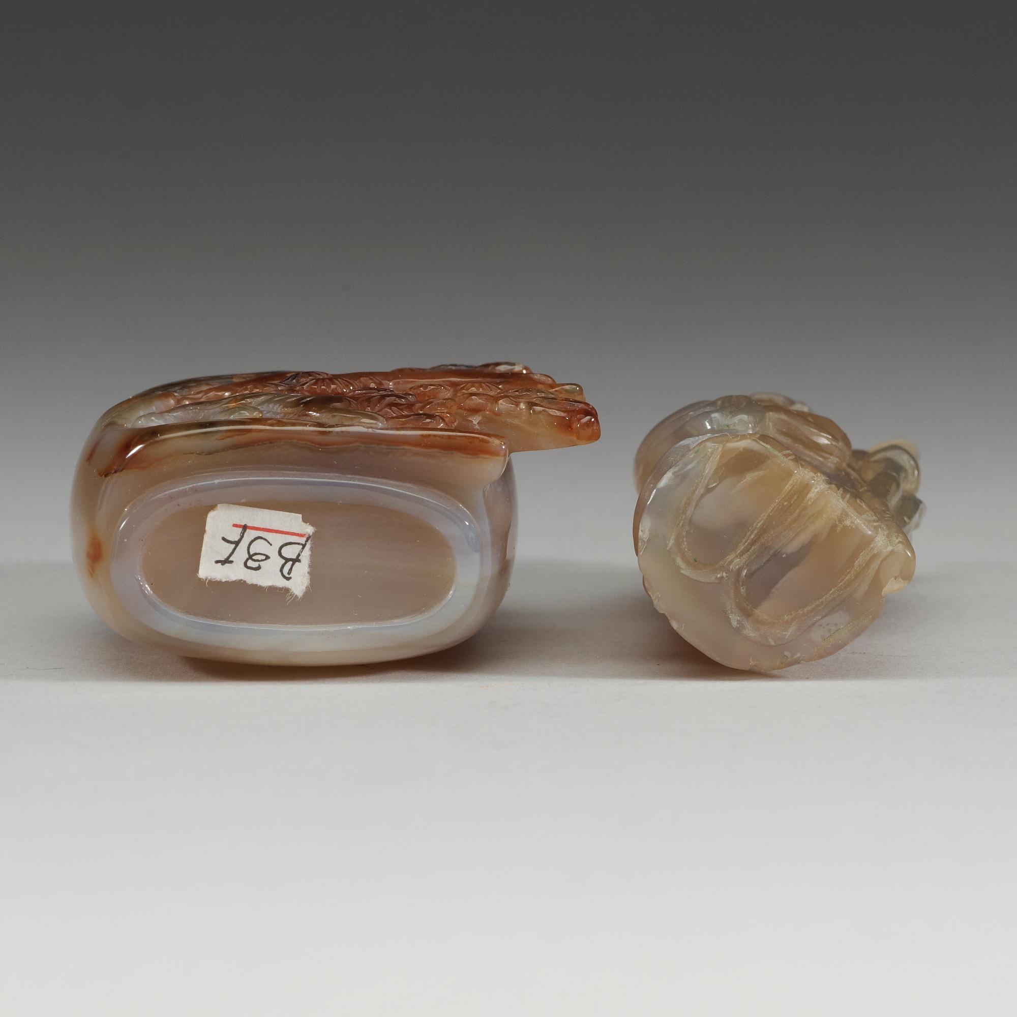 Two Chinese agate snuff bottles with stoppers.