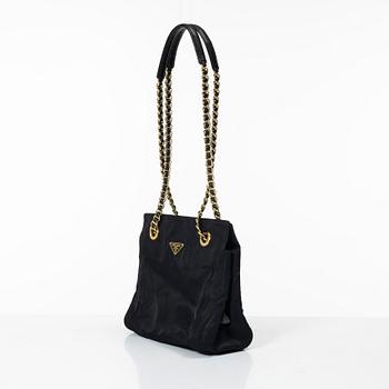 Prada, A black nylon bag.
