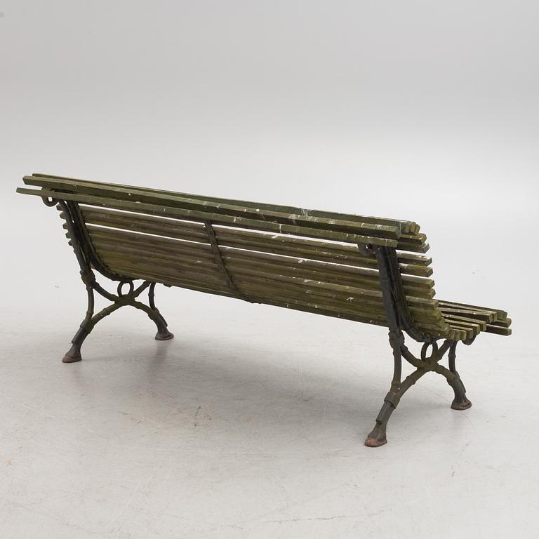 A cast iron-frame garden sofa, circa 1900.