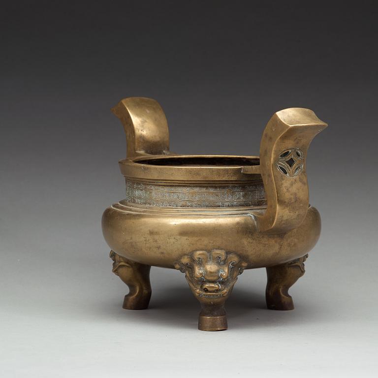 A large brass tripod censer, Qing dynasty (1644-1912).