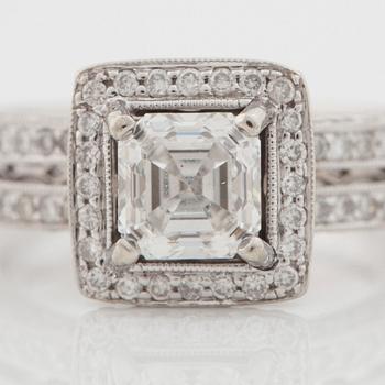 A 1.04 ct Assher cut diamond, quality F/VS1, ring. Shan with pavé set brilliant cut diamonds.