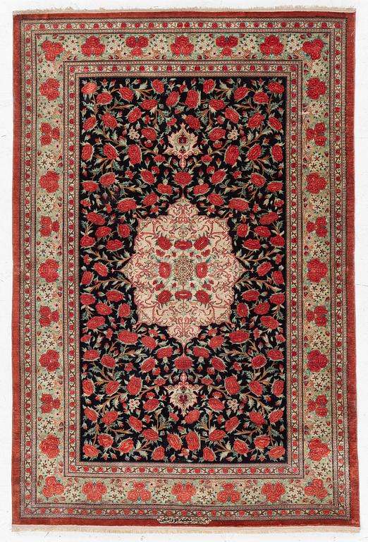 A signed silk Qum rug. c. 154 x 103 cm.