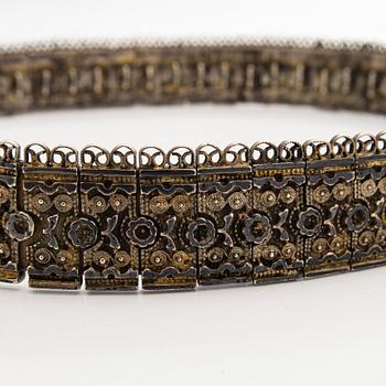 A Caucasian parcel-gilt costume belt with niello decor, 1908-26.