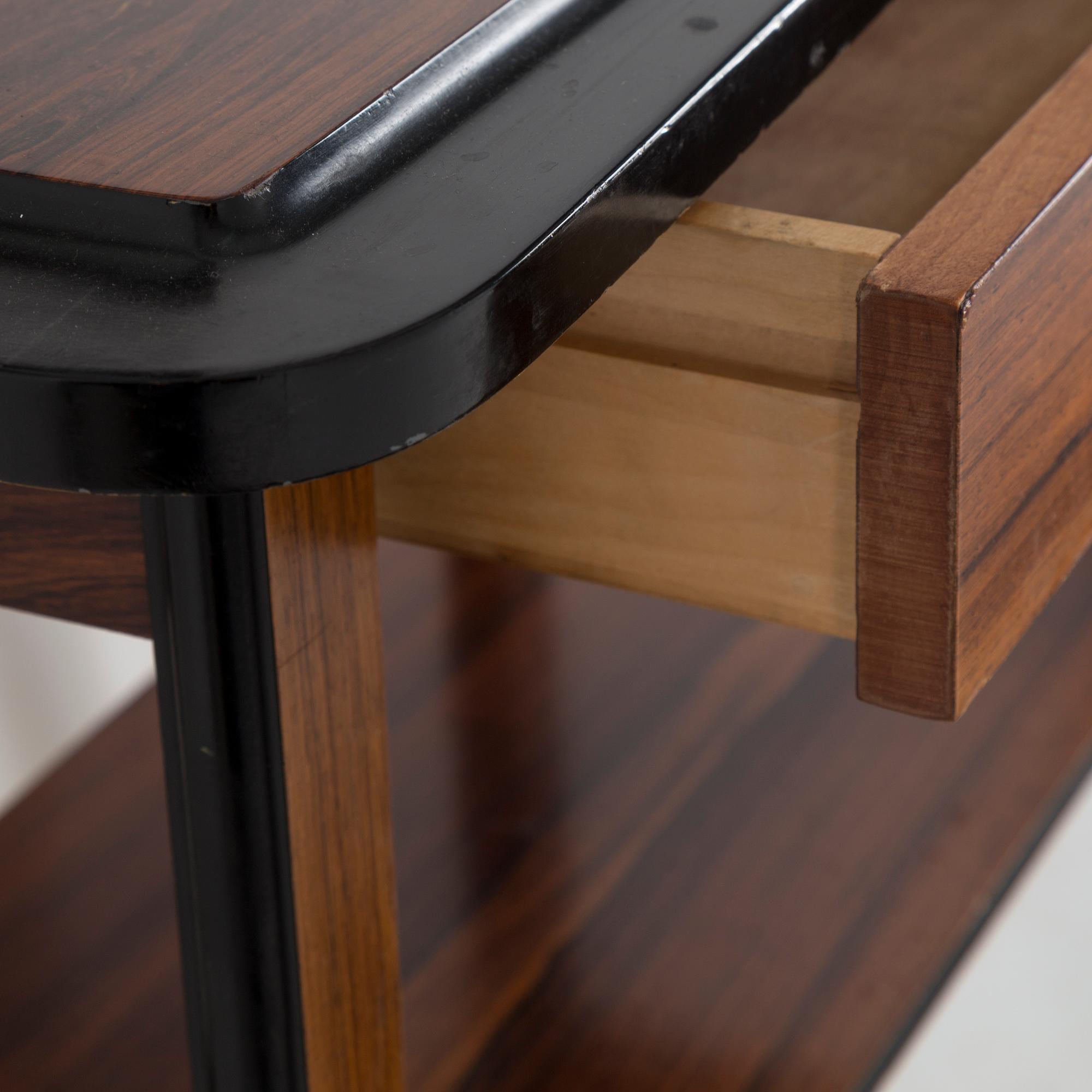 A second half of the 20th century rosewood mirror with table.