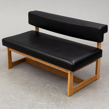 A leather covered oak sofa, 21st Century.