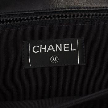 A bag CHOCOLATE BAR REISSUE by Chanel.