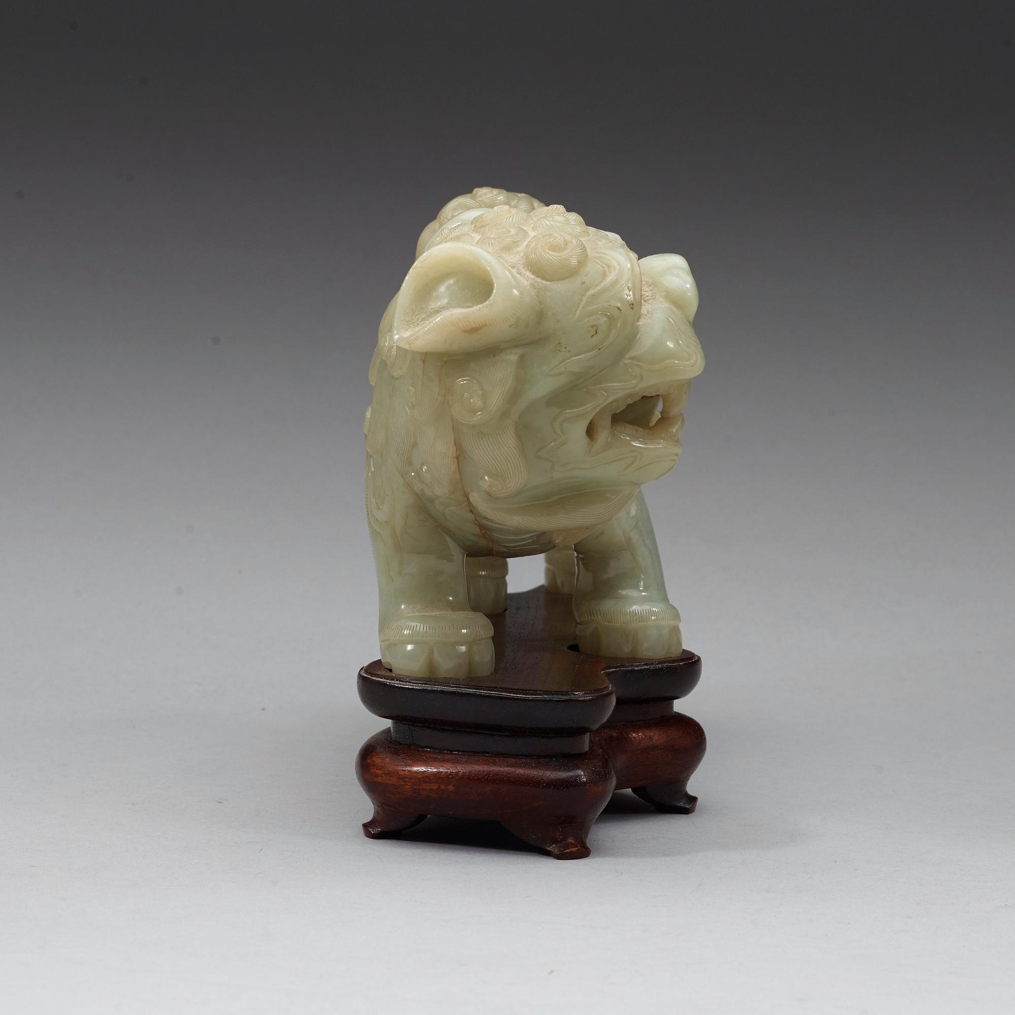 A green nephrite mytological lion, 20th century.
