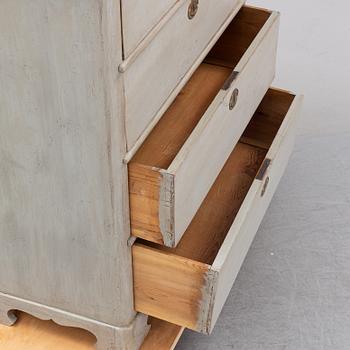 A painted chest of drawers from around the year 1900.