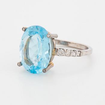 Oval faceted blue topaz and brilliant-cut diamond cocktail ring.