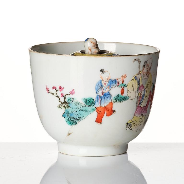 A famille rose 'trick cup' with a little figure, Qing dynasty, 19th Century.