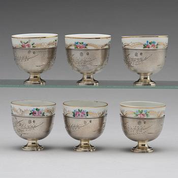 A set of six Ottoman parcel-gilt silver Xarfs with Russian Kuznetzov porcelain cups, c. 1910.