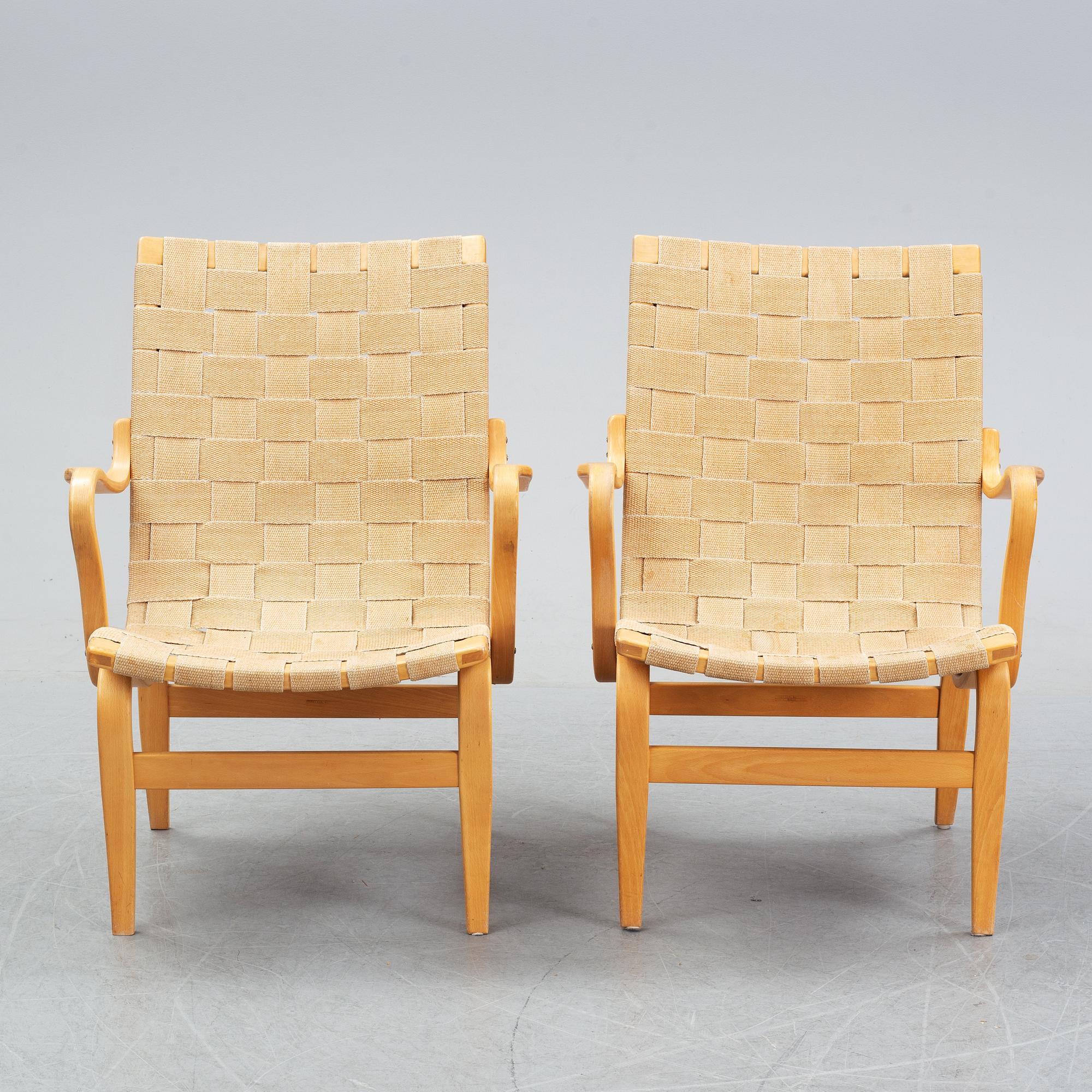 A pair of 'Eva' easy chairs by Bruno Mathsson for Firma Karl Mathsson, dated 1974.