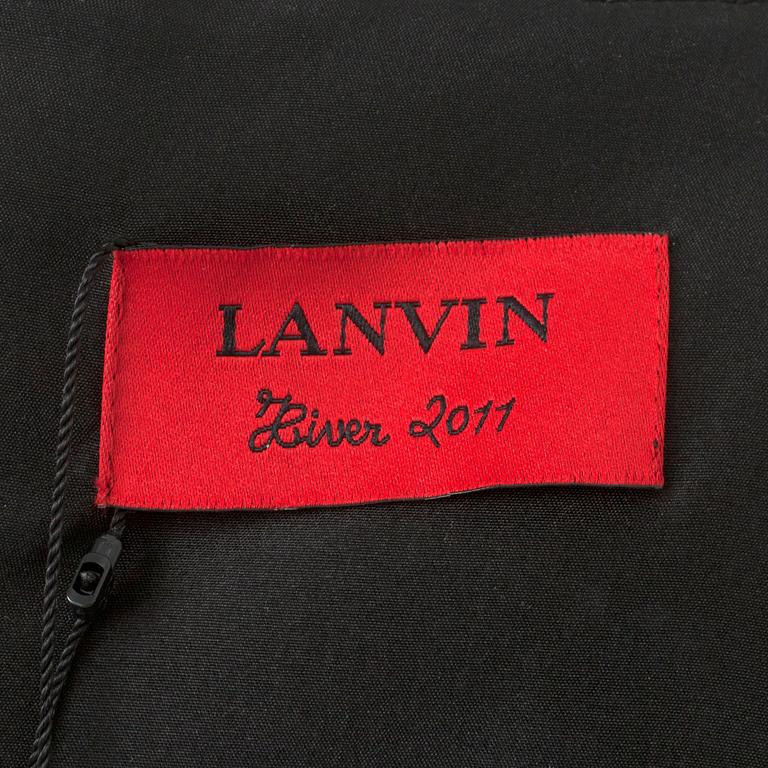 LANVIN, a black wool blend dress with ruffles.