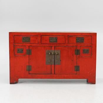 A Chinese red lacquered cabinet, 20th century.