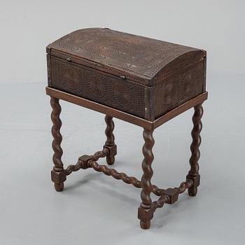 A late 18th or early 19th century wooden box on a stand from early 20th century.